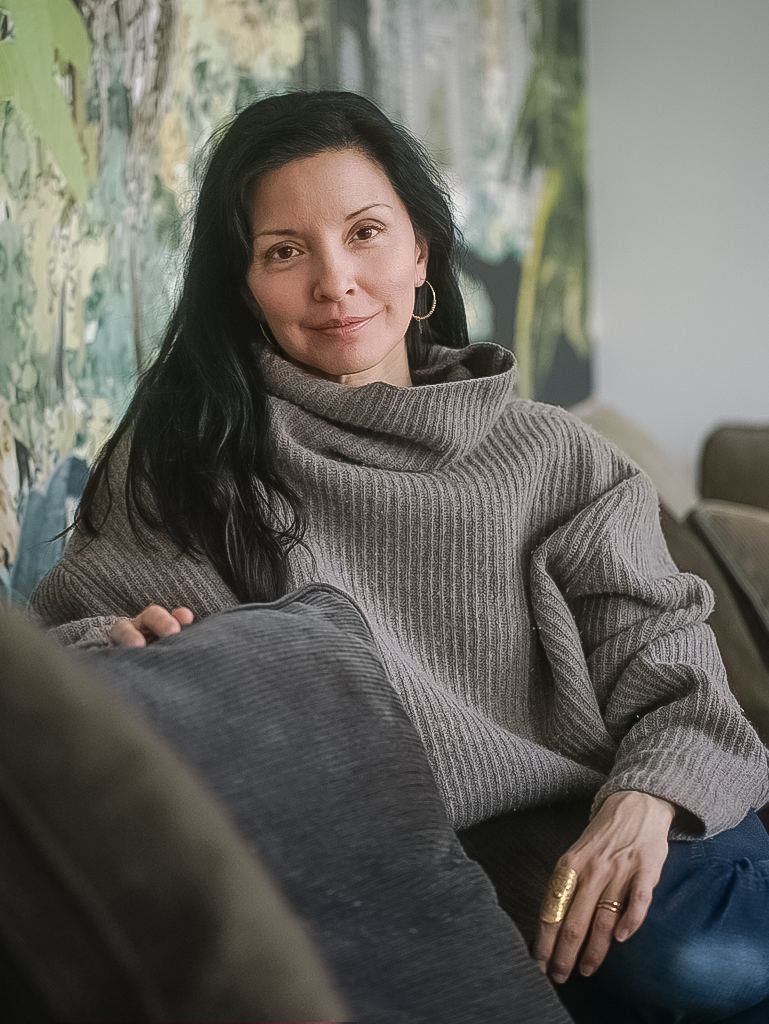 Photo of Michelle Wolter sitting comfortably on a sofa.